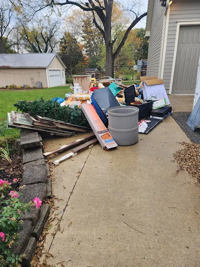 Dumpster being loaded with debris for Estate Cleanout Dumpster Rental in Oconomowoc
